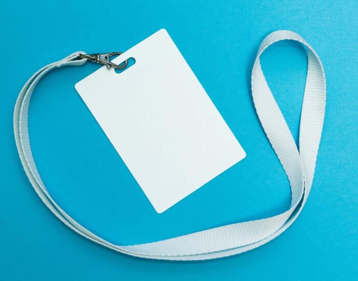 Blank badge or ID pass isolated on blue background, clipping pat
